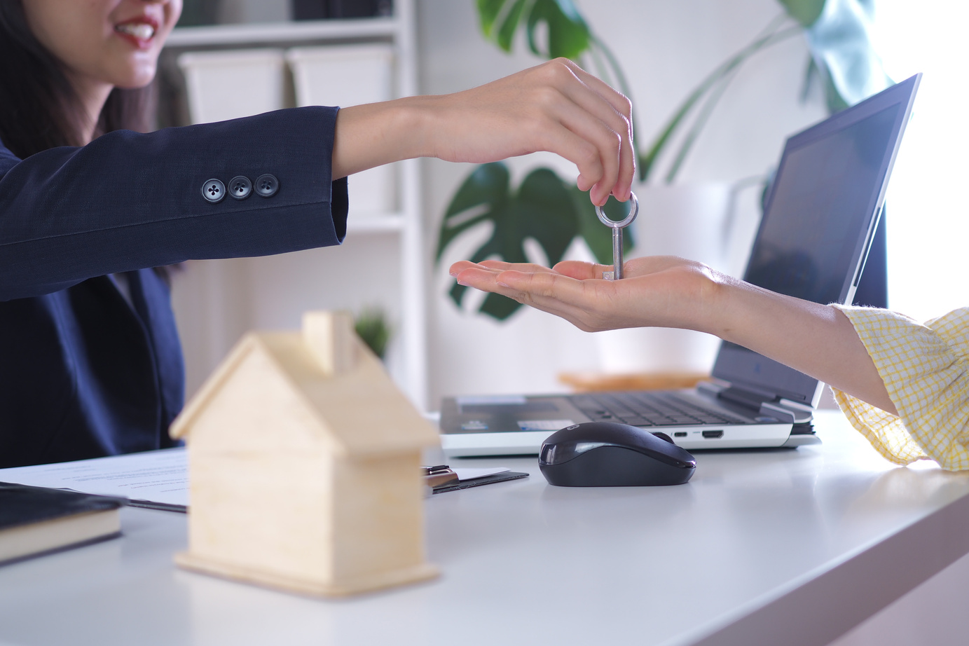 Woman Handing House Keys to Homeowner
